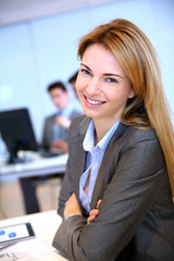 Portrait of cheerful businesswoman sitting in office