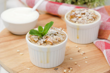 apple pie with walnuts and mint in a white ramekin horizontal
