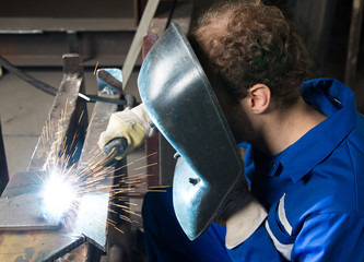 Man welding steel creating many sparks