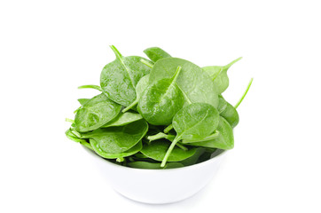 white bowl with fresh spinach isolated