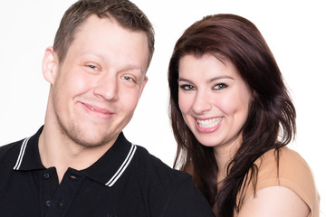 Young and happy couple in front of white background