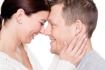 Young and happy couple in front of white background