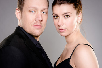 Young and happy couple in front of white background