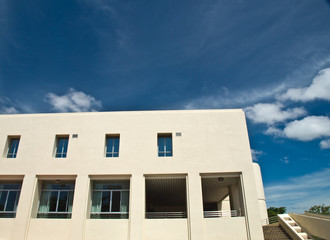 Obraz premium Facade windows of office building on blue sky