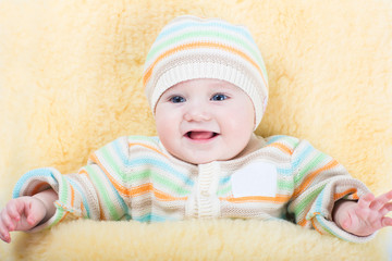 Little baby stroller sitting in warm sheep skin foot muff