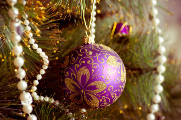christmas decorations hanging on christmas tree with shiny glare