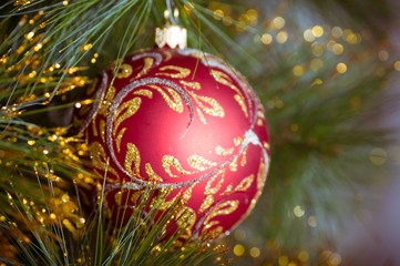 christmas decorations hanging on christmas tree with shiny glare