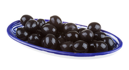 Olives black watered with olive oil in a bowl isolated on a whit