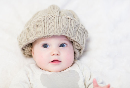 Sweet baby in a brown knitted hat