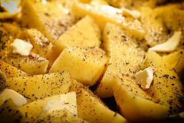Raw potatoes with spices ready to be roasted