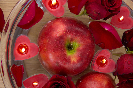 Valentine apple witn candles and rose petals