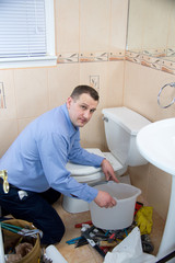 Plumber fixing toilet