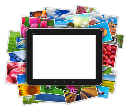 Blank tablet computer on heap of colorful photos