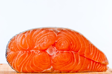 Red is a piece of salmon on a white background