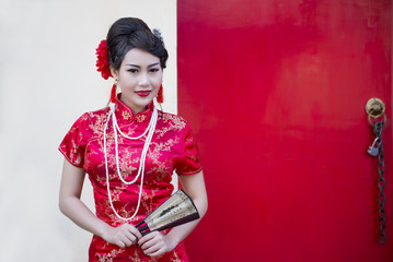 China boy in traditional Chinese red Tang suit greeting