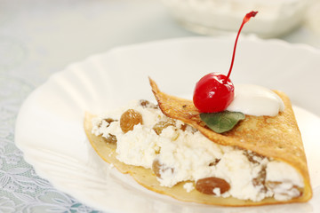 Pancake with cheese, cherry