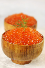Red caviar in wooden bowl