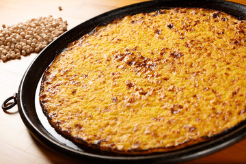 Typical Italian Pizza, ingredients in background on wood table