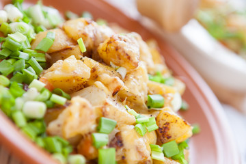 baked potato with cheese and greens on a dish