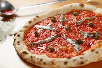 Cercles muraux Pizzeria Pizza italienne typique, ingrédients en arrière-plan sur table en bois