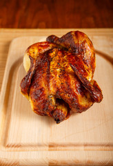 Whole Roast Chicken on Wood Cutting Board and Table