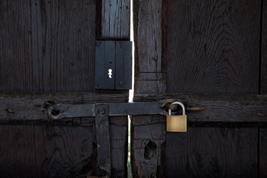 black wooden door with a padlock