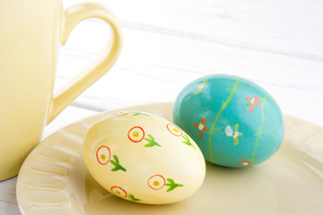 Painted easter eggs on light yellow plate