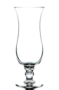 Empty hurricane cocktail glass on white background