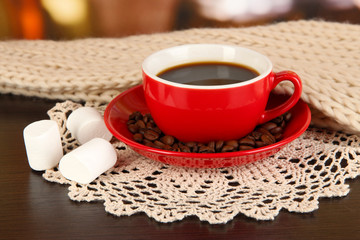 cup of coffee with scarf on table in room