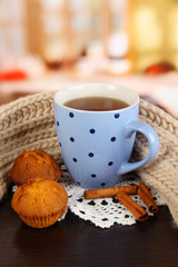 cup of tea with scarf on table in room