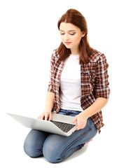 Naklejka premium Beautiful young woman with laptop isolated on white