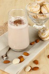 Glass of chocolate-cream cocktail on wooden table close-up