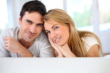 Portrait of in love couple sitting in sofa