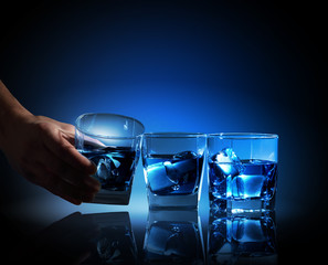 Three glasses of blue liquid