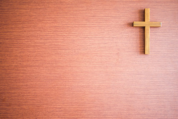 Cross on wooden texture