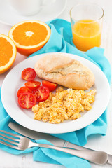 eggs with bread, tomato and orange juice