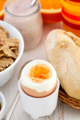 boiled egg with bread, cereals and juice