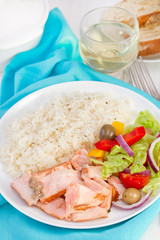 fish with rice and salad on the white plate