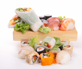 assortment of sushi on plank