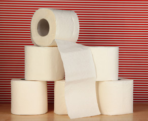 Rolls of toilet paper on striped red background