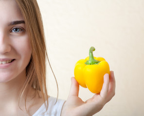 beautiful girl with yellow sweet pepper