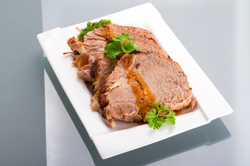 Slices of homemade roast pork on the plate