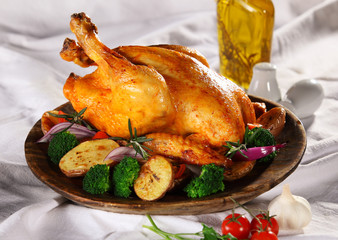 Roasted whole chicken on a plate with vegetables © Zsolt Biczó