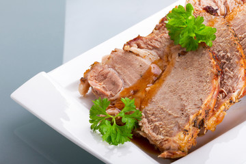 Slices of homemade roast pork on the plate