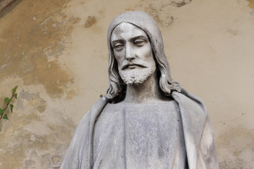 Fototapeta premium Historic Jesus on the old Prague Cemetery, Czech Republic