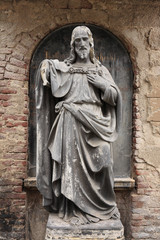 Fototapeta na wymiar Historic Jesus on the old Prague Cemetery, Czech Republic
