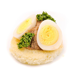 Sandwich with quail egg, paste and parsley.