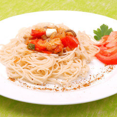 plate of spaghetti with mushrooms and tomatoes
