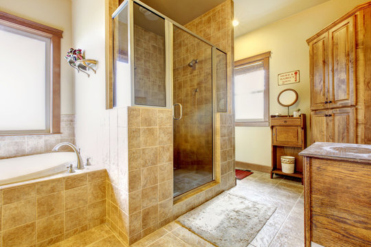 Large bathroom with wood furniture and natural colors.