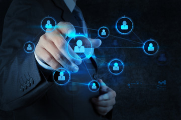 Businessman pressing modern social buttons on a virtual